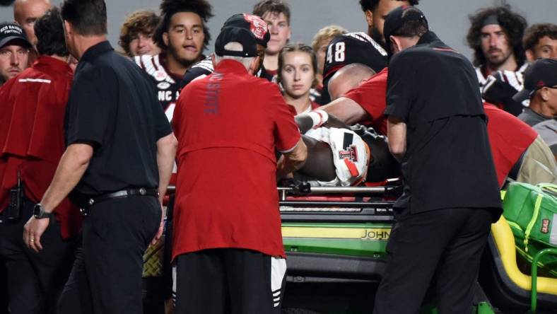 Sep 17, 2022; Raleigh, North Carolina, USA; Texas Tech Red Raiders linebacker Bryce Ramirez (54) is carted off the field after suffering an apparent injury during the first half against the North Carolina State Wolfpack at Carter-Finley Stadium. Mandatory Credit: Rob Kinnan-USA TODAY Sports