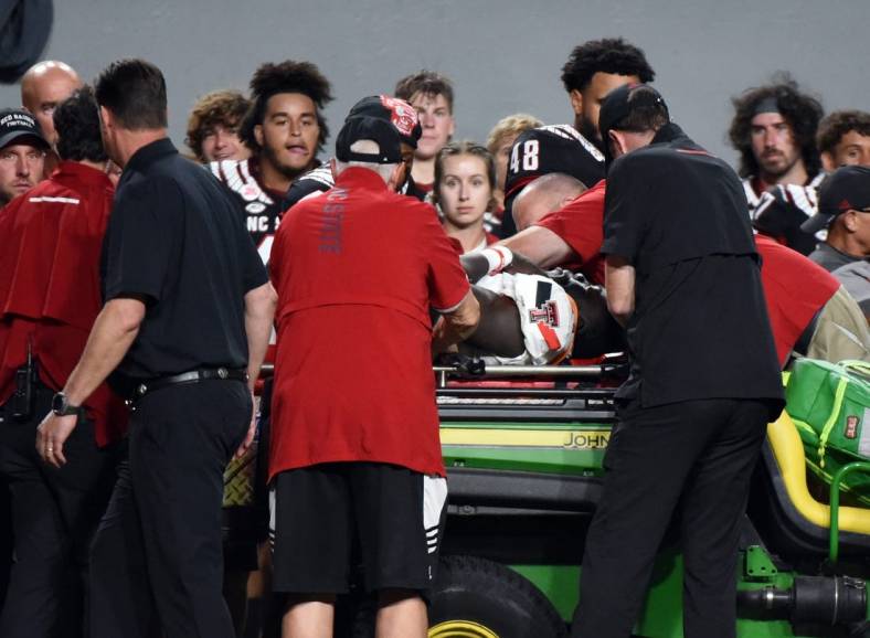 Sep 17, 2022; Raleigh, North Carolina, USA; Texas Tech Red Raiders linebacker Bryce Ramirez (54) is carted off the field after suffering an apparent injury during the first half against the North Carolina State Wolfpack at Carter-Finley Stadium. Mandatory Credit: Rob Kinnan-USA TODAY Sports