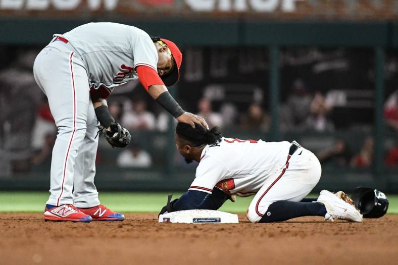 Sep 17, 2022; Cumberland, Georgia, USA; Atlanta Braves second baseman Ozzie Albies (1) is checked on by second baseman Jean Segura (2) after sliding into second against the Philadelphia Phillies in the fourth inning at Truist Park. Mandatory Credit: Larry Robinson-USA TODAY Sports