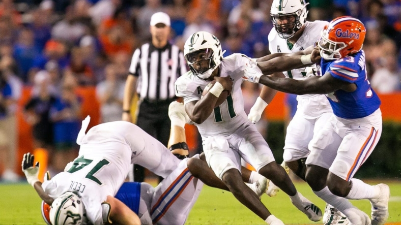 South Florida Bulls quarterback Gerry Bohanon (11) tries to elude Florida Gators in the second half against the Bulls at Steve Spurrier Field at Ben Hill Griffin Stadium in Gainesville, FL on Saturday, September 17, 2022. Florida won 31-28 [Doug Engle/Gainesville Sun]Ncaa Football Florida Gators Vs Usf Bulls