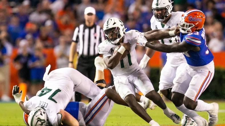 South Florida Bulls quarterback Gerry Bohanon (11) tries to elude Florida Gators in the second half against the Bulls at Steve Spurrier Field at Ben Hill Griffin Stadium in Gainesville, FL on Saturday, September 17, 2022. Florida won 31-28 [Doug Engle/Gainesville Sun]

Ncaa Football Florida Gators Vs Usf Bulls