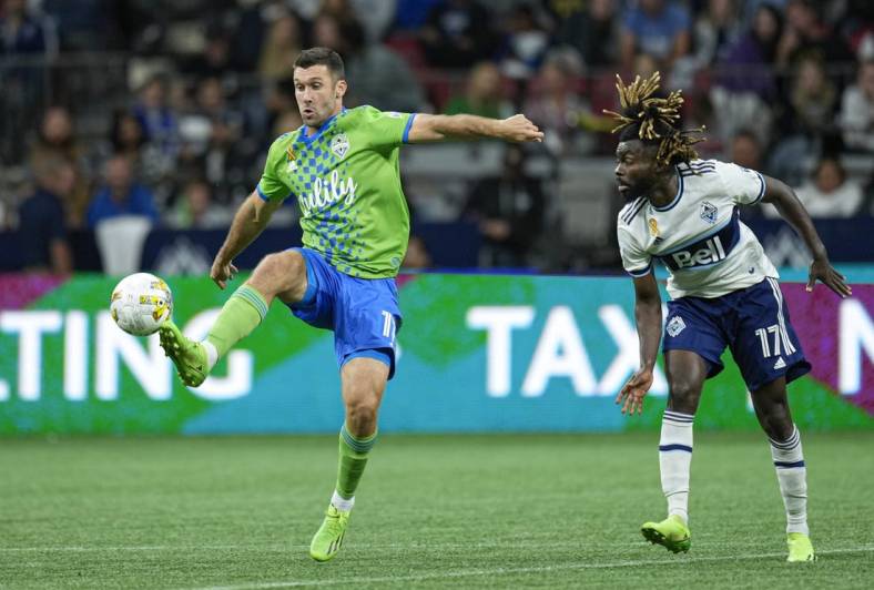 Sep 17, 2022; Vancouver, British Columbia, CAN; Seattle Sounders midfielder Albert Rusnak (11) wins control of the ball while battling with Vancouver Whitecaps midfielder Leonard Owusu (17) in the second half at BC Place. Mandatory Credit: Bob Frid-USA TODAY Sports