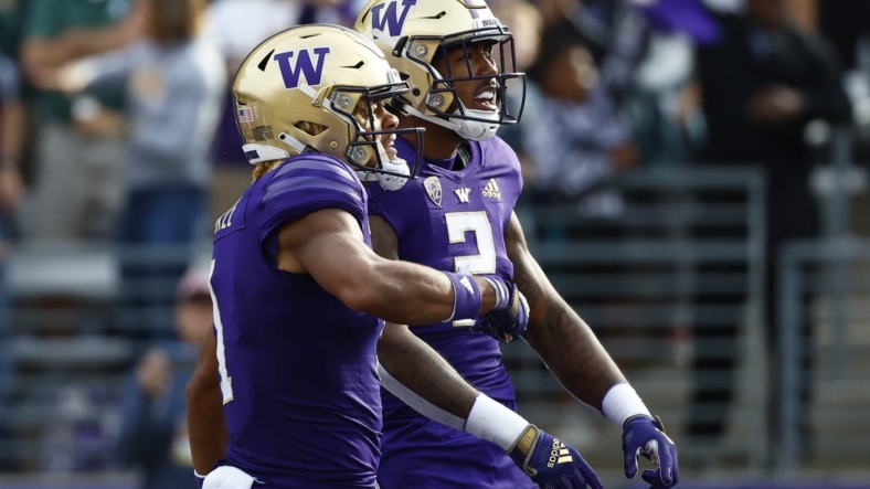 Sep 17, 2022; Seattle, Washington, USA; Washington Huskies wide receiver Ja'Lynn Polk (2) celebrates with wide receiver Rome Odunze (1) after catching a touchdown pass against the Michigan State Spartans during the first quarter at Alaska Airlines Field at Husky Stadium. Mandatory Credit: Joe Nicholson-USA TODAY Sports