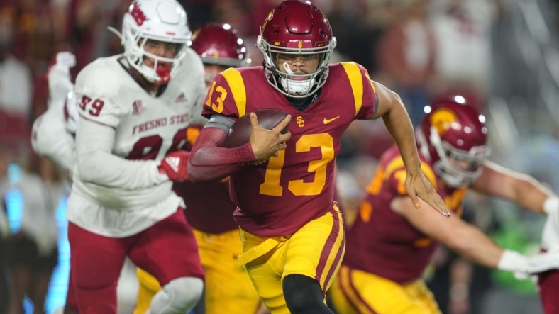 Sep 17, 2022; Los Angeles, California, USA; Southern California Trojans quarterback Caleb Williams (13) carries the ball against the Fresno State Bulldogs] in the first half at United Airlines Field at Los Angeles Memorial Coliseum. Mandatory Credit: Kirby Lee-USA TODAY Sports