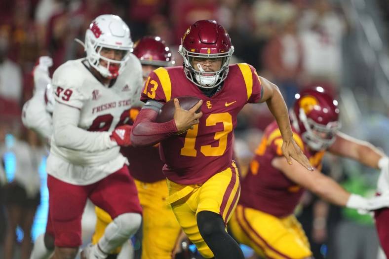 Sep 17, 2022; Los Angeles, California, USA; Southern California Trojans quarterback Caleb Williams (13) carries the ball against the Fresno State Bulldogs] in the first half at United Airlines Field at Los Angeles Memorial Coliseum. Mandatory Credit: Kirby Lee-USA TODAY Sports