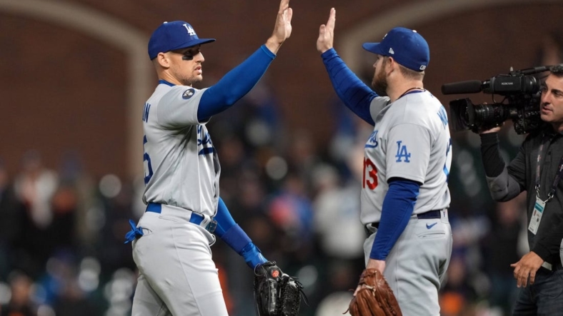 Sep 17, 2022; San Francisco, California, USA; Los Angeles Dodgers center fielder Trayce Thompson (25, left) and third baseman Max Muncy (13, right) celebrate after defeating the San Francisco Giants at Oracle Park. Mandatory Credit: Darren Yamashita-USA TODAY Sports