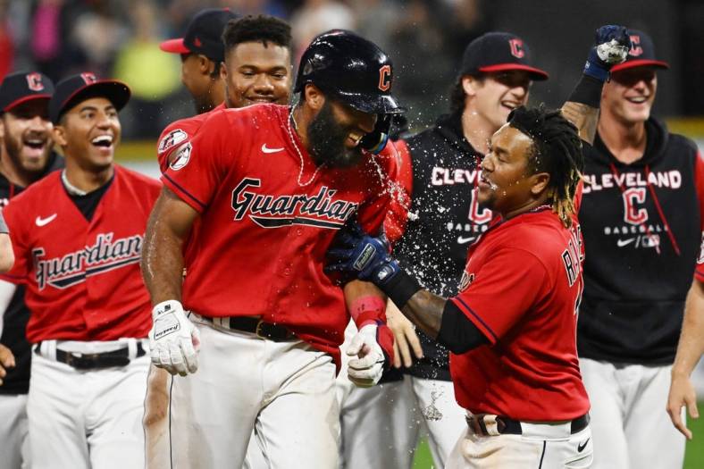 Sep 17, 2022; Cleveland, Ohio, USA; Cleveland Guardians shortstop Amed Rosario, middle, celebrates with teammates after hitting an RBI single to win the game during the fifteenth inning against the Minnesota Twins at Progressive Field. Mandatory Credit: Ken Blaze-USA TODAY Sports