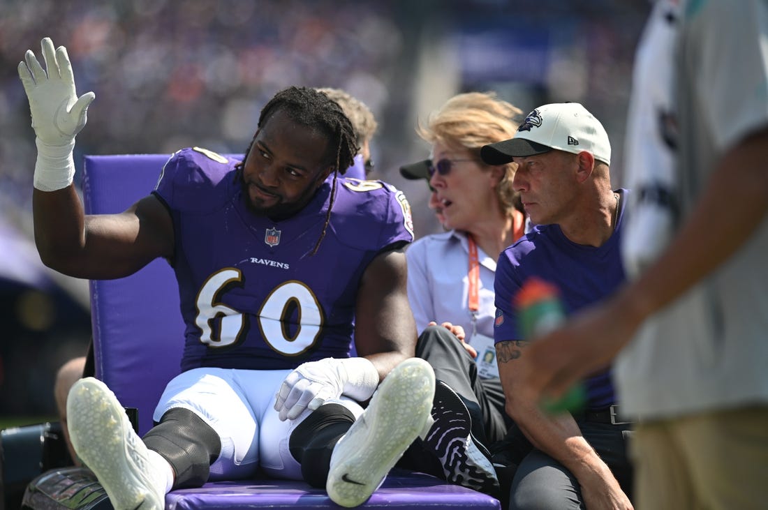 Sep 18, 2022; Baltimore, Maryland, USA;  Baltimore Ravens linebacker Steven Means (60) waves while being carted off the field during the second quarter against the Miami Dolphins at M&T Bank Stadium. Mandatory Credit: Tommy Gilligan-USA TODAY Sports