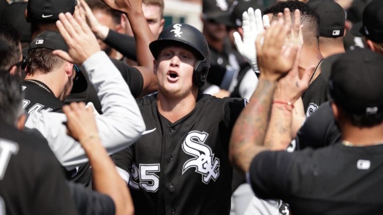 Sep 18, 2022; Detroit, Michigan, USA;  Chicago White Sox first baseman Andrew Vaughn (25) high-fives teammates after hitting a grand slam in the fifth inning of the game against the Detroit Tigers at Comerica Park. Mandatory Credit: Brian Sevald-USA TODAY Sports
