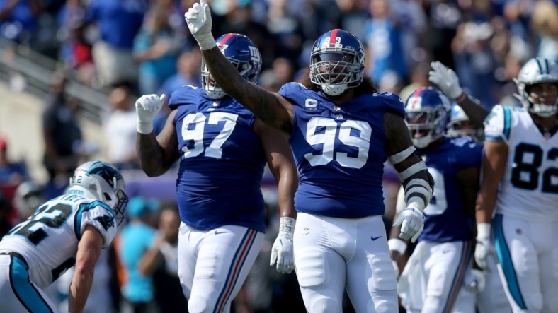 Sep 18, 2022; East Rutherford, New Jersey, USA; New York Giants defensive end Leonard Williams (99) and defensive tackle Dexter Lawrence (97) celebrate after Carolina Panthers turn the ball over on downs during the second quarter at MetLife Stadium. Mandatory Credit: Brad Penner-USA TODAY Sports