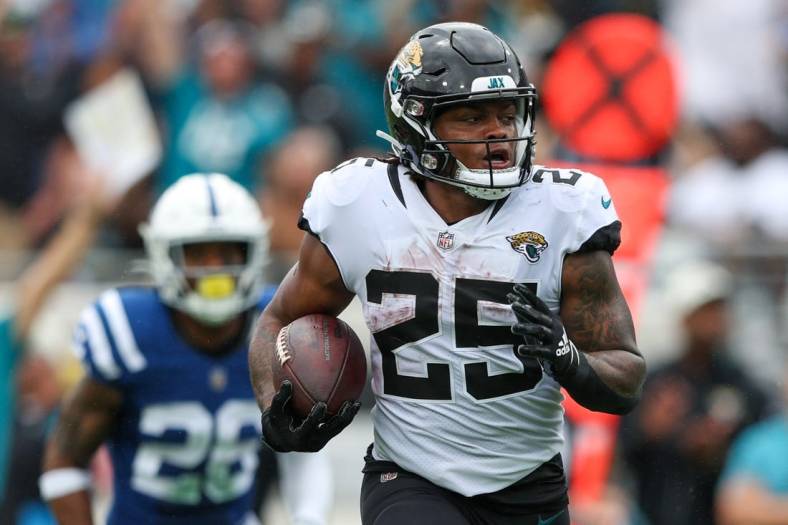 Sep 18, 2022; Jacksonville, Florida, USA;  Jacksonville Jaguars running back James Robinson (25) runs for a touchdown against the Indianapolis Colts in the second quarter at TIAA Bank Field. Mandatory Credit: Nathan Ray Seebeck-USA TODAY Sports