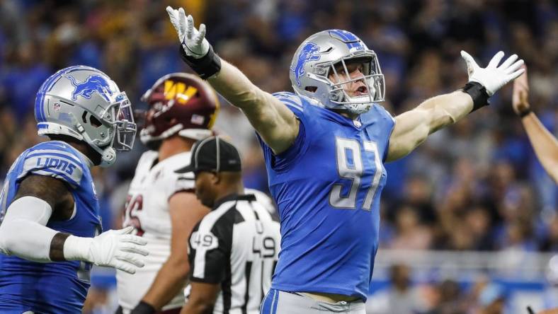 Sep 18, 2022; Detroit, Michigan, USA;  Detroit Lions defensive end Aidan Hutchinson (97) celebrates a sack against  Washington Commanders quarterback Carson Wentz (11) during the first half at Ford Field. Mandatory Credit: Junfu Han-USA TODAY Sports