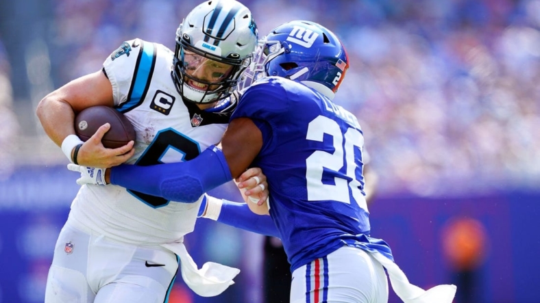 New York Giants safety Julian Love (20) shoves Carolina Panthers quarterback Baker Mayfield (6) out of bounds before the first down in the first half of an NFL game at MetLife Stadium on Sunday, Sept. 18, 2022, in East Rutherford.Nfl Ny Giants Vs Carolina Panthers Panthers At Giants