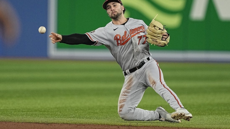 Sep 18, 2022; Toronto, Ontario, CAN; Baltimore Orioles second baseman Terrin Vavra (77) throws to first but can t get out Toronto Blue Jays center fielder Raimel Tapia (not pictured) during the second inning at Rogers Centre. Mandatory Credit: John E. Sokolowski-USA TODAY Sports