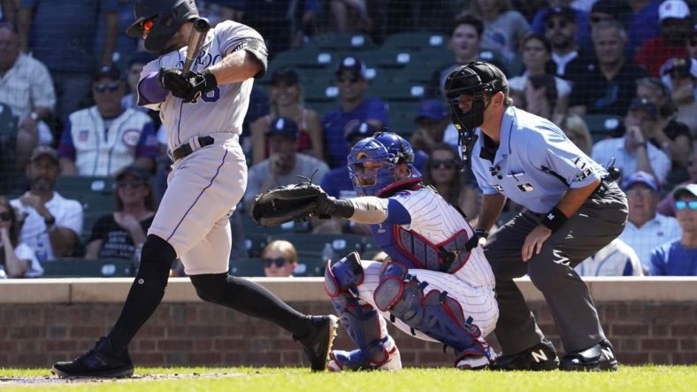 Sep 18, 2022; Chicago, Illinois, USA; Colorado Rockies right fielder Randal Grichuk (15) hits a two-run single against the Chicago Cubs during the first inning at Wrigley Field. Mandatory Credit: David Banks-USA TODAY Sports