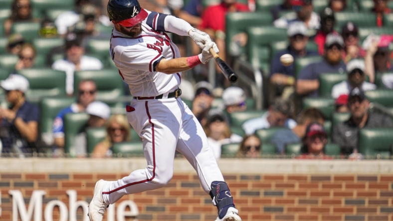 Sep 18, 2022; Cumberland, Georgia, USA; Atlanta Braves left fielder Robbie Grossman (15) hits a single to drive in a run against the Philadelphia Phillies during the third inning at Truist Park. Mandatory Credit: Dale Zanine-USA TODAY Sports