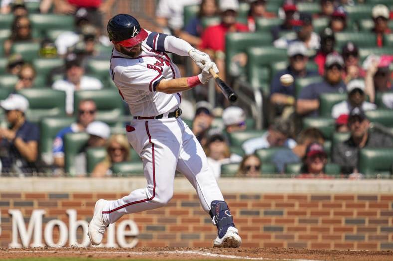 Sep 18, 2022; Cumberland, Georgia, USA; Atlanta Braves left fielder Robbie Grossman (15) hits a single to drive in a run against the Philadelphia Phillies during the third inning at Truist Park. Mandatory Credit: Dale Zanine-USA TODAY Sports