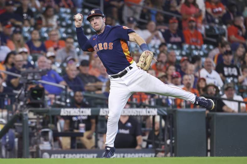 Sep 18, 2022; Houston, Texas, USA; Houston Astros third baseman Alex Bregman (2) throws to first base on a play during the fifth inning against the Oakland Athletics at Minute Maid Park. Mandatory Credit: Troy Taormina-USA TODAY Sports