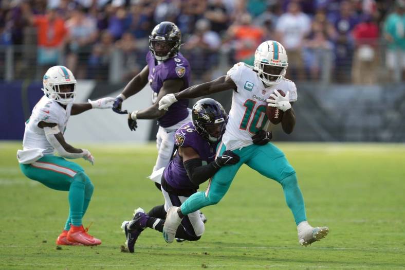 Sep 18, 2022; Baltimore, Maryland, USA; Miami Dolphins wide receiver Tyreek Hill (10) gains yardage after his catch in the fourth quarter defended by Baltimore Ravens safety Chuck Clark (36) at M&T Bank Stadium. Mandatory Credit: Mitch Stringer-USA TODAY Sports