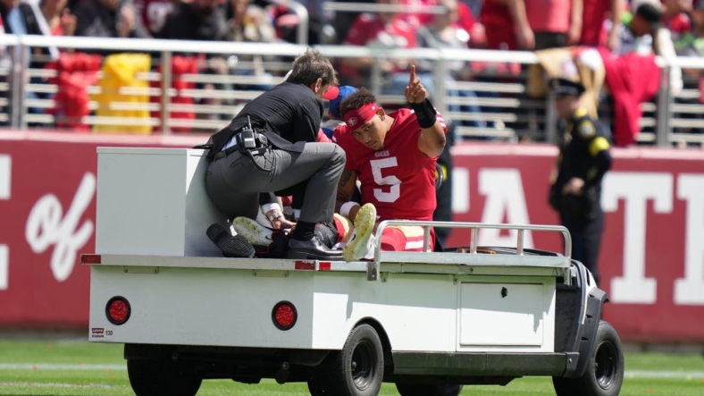 September 18, 2022; Santa Clara, California, USA; San Francisco 49ers quarterback Trey Lance (5) is carted off the field after an injury against the Seattle Seahawks during the first quarter at Levi's Stadium. Mandatory Credit: Kyle Terada-USA TODAY Sports