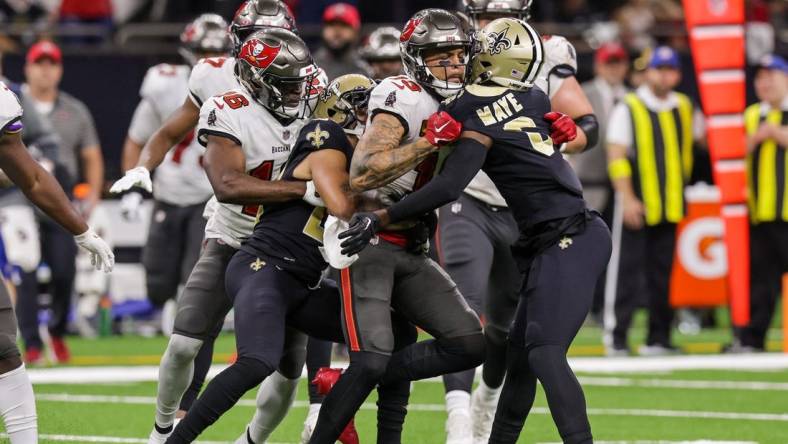 Sep 18, 2022; New Orleans, Louisiana, USA;  New Orleans Saints cornerback Marshon Lattimore (23) and safety Marcus Maye (6) get into a penalty with Tampa Bay Buccaneers wide receiver Mike Evans (13) and they are ejected after the play during the second half at Caesars Superdome. Mandatory Credit: Stephen Lew-USA TODAY Sports