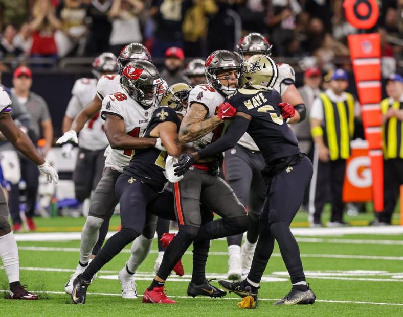Sep 18, 2022; New Orleans, Louisiana, USA;  New Orleans Saints cornerback Marshon Lattimore (23) and safety Marcus Maye (6) get into a penalty with Tampa Bay Buccaneers wide receiver Mike Evans (13) and they are ejected after the play during the second half at Caesars Superdome. Mandatory Credit: Stephen Lew-USA TODAY Sports