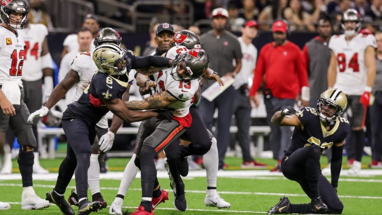 Sep 18, 2022; New Orleans, Louisiana, USA;  New Orleans Saints cornerback Marshon Lattimore (23) and safety Marcus Maye (6) get into a penalty with Tampa Bay Buccaneers wide receiver Mike Evans (13) and they are ejected after the play during the second half at Caesars Superdome. Mandatory Credit: Stephen Lew-USA TODAY Sports