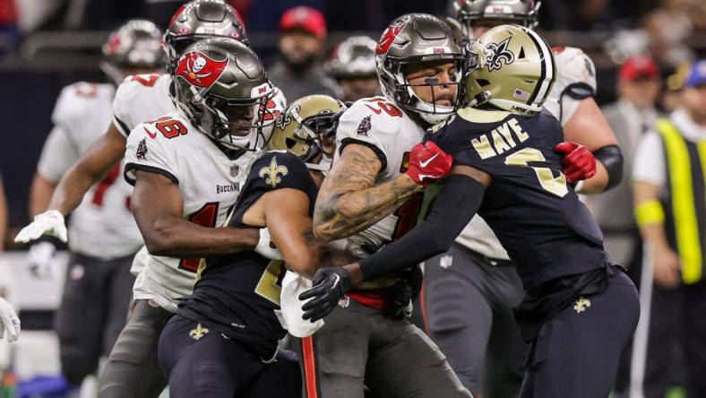 Sep 18, 2022; New Orleans, Louisiana, USA;  New Orleans Saints cornerback Marshon Lattimore (23) and safety Marcus Maye (6) get into a penalty with Tampa Bay Buccaneers wide receiver Mike Evans (13) and they are ejected after the play during the second half at Caesars Superdome. Mandatory Credit: Stephen Lew-USA TODAY Sports