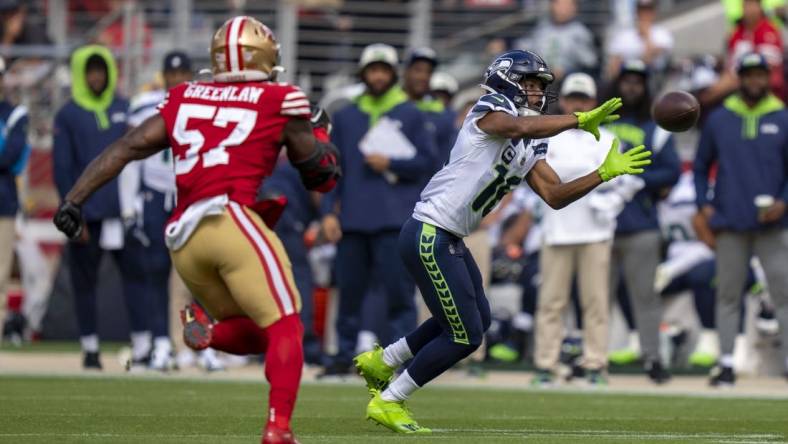 September 18, 2022; Santa Clara, California, USA; Seattle Seahawks wide receiver Tyler Lockett (16) catches the football against San Francisco 49ers linebacker Dre Greenlaw (57) during the second quarter at Levi's Stadium. Mandatory Credit: Kyle Terada-USA TODAY Sports