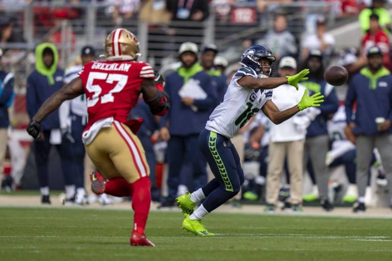 September 18, 2022; Santa Clara, California, USA; Seattle Seahawks wide receiver Tyler Lockett (16) catches the football against San Francisco 49ers linebacker Dre Greenlaw (57) during the second quarter at Levi's Stadium. Mandatory Credit: Kyle Terada-USA TODAY Sports