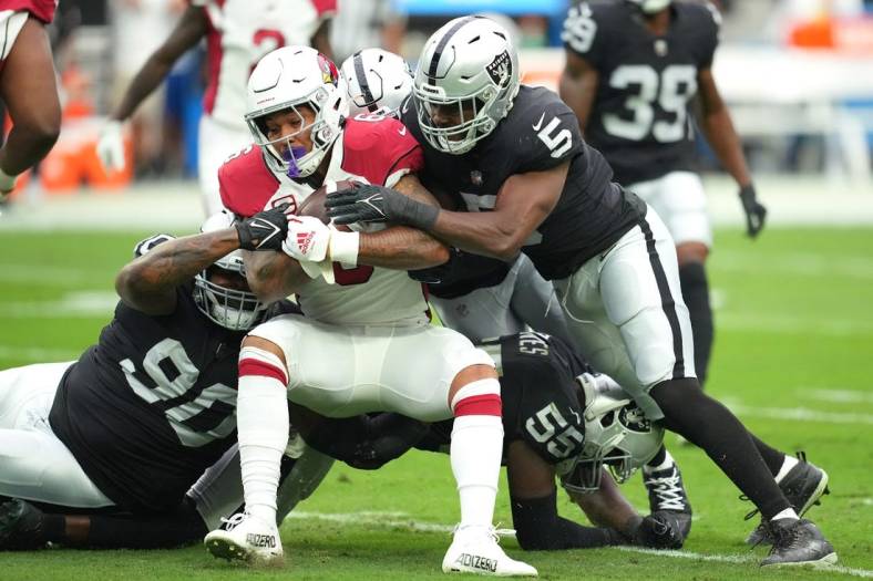Sep 18, 2022; Paradise, Nevada, USA; Arizona Cardinals running back James Conner (6) is tackled by Las Vegas Raiders defensive tackle Johnathan Hankins (90) and Las Vegas Raiders linebacker Divine Deablo (5) during a game at Allegiant Stadium. Mandatory Credit: Stephen R. Sylvanie-USA TODAY Sports