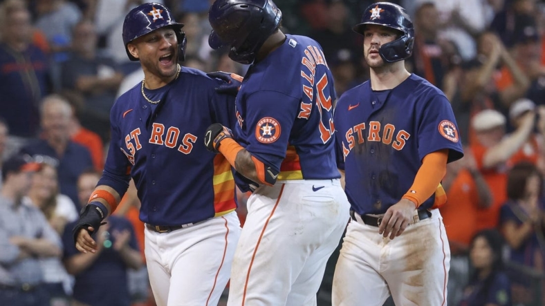 Sep 18, 2022; Houston, Texas, USA; Houston Astros catcher Martin Maldonado (15) celebrates with first baseman Yuli Gurriel (10) after hitting a home run during the seventh inning against the Oakland Athletics at Minute Maid Park. Mandatory Credit: Troy Taormina-USA TODAY Sports