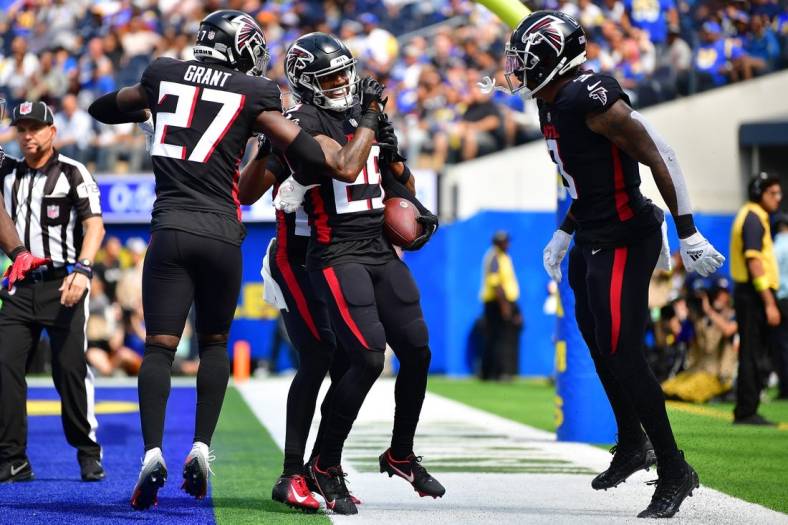 Sep 18, 2022; Inglewood, California, USA; Atlanta Falcons cornerback Casey Hayward (29) is greeted by linebacker Mykal Walker (3) and safety Richie Grant (27) after intercepting a pass intended for Los Angeles Rams tight end Tyler Higbee (89) during the first half at SoFi Stadium. Mandatory Credit: Gary A. Vasquez-USA TODAY Sports