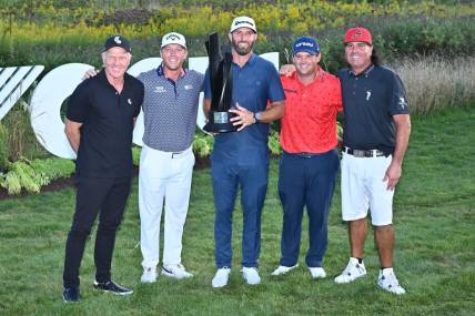 Sep 18, 2022; Chicago, Illinois, USA; LIV Golf CEO Greg Norman, far left, poses with Talor Gooch, Dustin Johnson, Patrick Reed and Pat Perez, all members of the 4 Aces GC, after they won the team competition of the Invitational Chicago LIV Golf tournament at Rich Harvest Farms. Mandatory Credit: Jamie Sabau-USA TODAY Sports