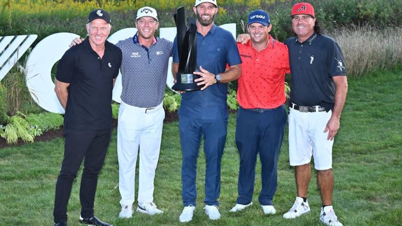 Sep 18, 2022; Chicago, Illinois, USA; LIV Golf CEO Greg Norman, far left, poses with Talor Gooch, Dustin Johnson, Patrick Reed and Pat Perez, all members of the 4 Aces GC, after they won the team competition of the Invitational Chicago LIV Golf tournament at Rich Harvest Farms. Mandatory Credit: Jamie Sabau-USA TODAY Sports