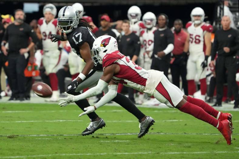 Sep 18, 2022; Paradise, Nevada, USA; Arizona Cardinals safety Jalen Thompson (34) attempts to intercept a pass intended for Las Vegas Raiders wide receiver Davante Adams (17) in overtime at Allegiant Stadium. Mandatory Credit: Kirby Lee-USA TODAY Sports