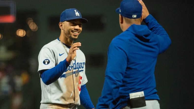 Sep 18, 2022; San Francisco, California, USA;  Los Angeles Dodgers right fielder Mookie Betts (50) celebrates with a team mate after defeating the San Francisco Giants at Oracle Park. Mandatory Credit: Ed Szczepanski-USA TODAY Sports
