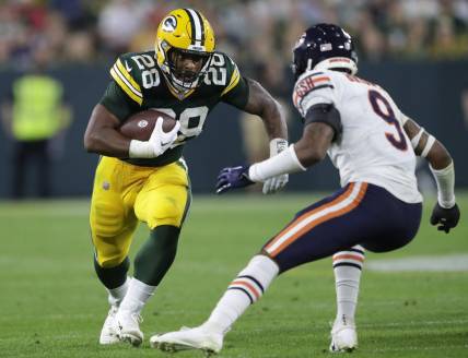 Sep 18, 2022; Green Bay, Wisconsin, USA; Green Bay Packers running back AJ Dillon (28) runs for a first down against Chicago Bears safety Jaquan Brisker (9) in the third quarter during their football game at Lambeau Field. Mandatory Credit: Dan Powers/USA TODAY NETWORK-Wisconsin
