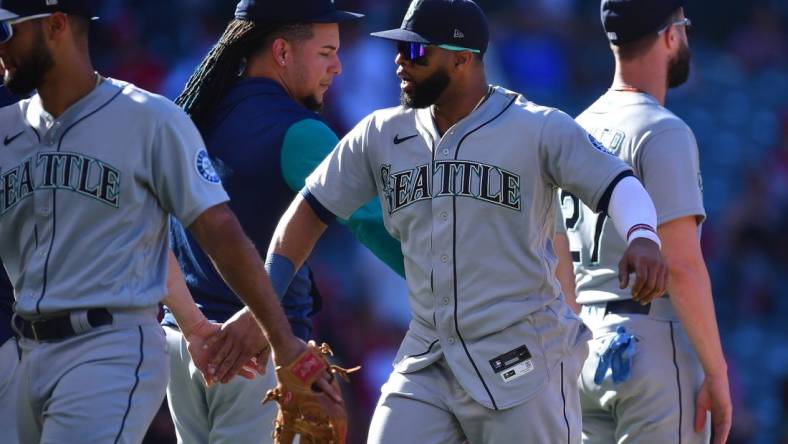 Sep 19, 2022; Anaheim, California, USA; Seattle Mariners designated hitter Carlos Santana (41) celebrates the victory against the Los Angeles Angels at Angel Stadium. Mandatory Credit: Gary A. Vasquez-USA TODAY Sports