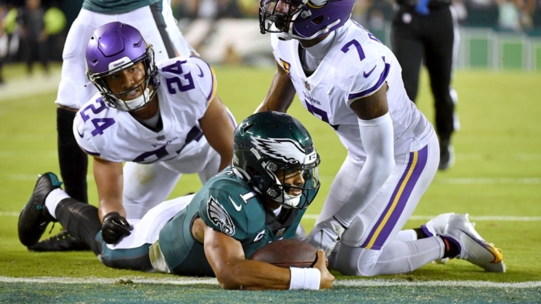 Sep 19, 2022; Philadelphia, Pennsylvania, USA; Philadelphia Eagles quarterback Jalen Hurts (1) scores on a 26-yard touchdown run against Minnesota Vikings cornerback Patrick Peterson (7) and safety Camryn Bynum (24) during the second quarter at Lincoln Financial Field. Mandatory Credit: Eric Hartline-USA TODAY Sports