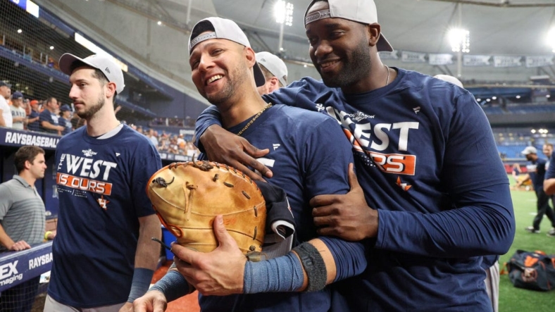 Sep 19, 2022; St. Petersburg, Florida, USA;  Houston Astros first baseman Yuli Gurriel (10) and left fielder Yordan Alvarez (44) celebrate after winning the American League West division at Tropicana Field. Mandatory Credit: Nathan Ray Seebeck-USA TODAY Sports