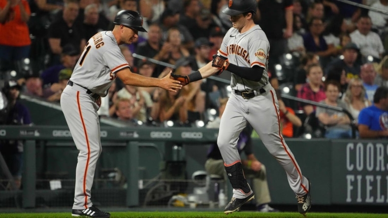 Sep 19, 2022; Denver, Colorado, USA; San Francisco Giants center fielder Mike Yastrzemski (5) is congratulated for his solo home run by third base coach Mark Hallberg (91) in the fourth inning against the Colorado Rockies at Coors Field. Mandatory Credit: Ron Chenoy-USA TODAY Sports