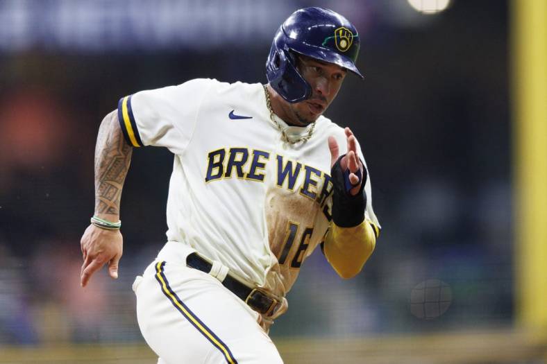 Sep 20, 2022; Milwaukee, Wisconsin, USA;  Milwaukee Brewers second baseman Kolten Wong (16) rounds third base before scoring a run during the second inning against the New York Mets at American Family Field. Mandatory Credit: Jeff Hanisch-USA TODAY Sports