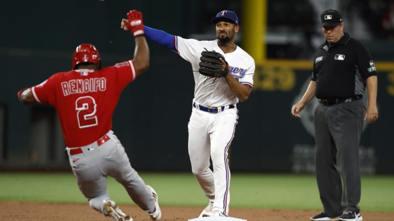 Sep 20, 2022; Arlington, Texas, USA; Texas Rangers second baseman Marcus Semien (2) turns a double play on Los Angeles Angels second baseman Luis Rengifo (2) in the first inning at Globe Life Field. Mandatory Credit: Tim Heitman-USA TODAY Sports