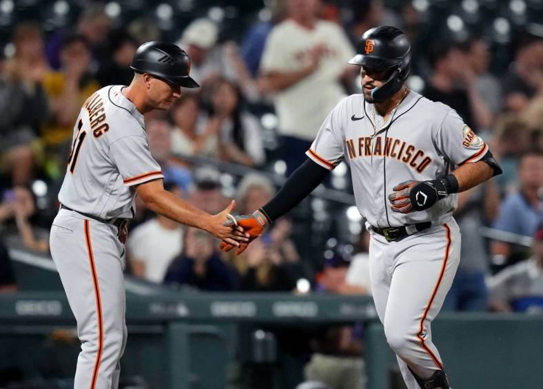 Sep 20, 2022; Denver, Colorado, USA; San Francisco Giants third baseman David Villar (70) is congratulated for his solo home run by third base coach Mark Hallberg (91) in the seventh inning at Coors Field. Mandatory Credit: Ron Chenoy-USA TODAY Sports