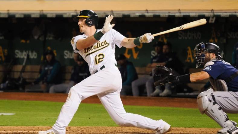 Sep 20, 2022; Oakland, California, USA; Oakland Athletics catcher Sean Murphy (12) hits an RBI double against the Seattle Mariners during the fifth inning at RingCentral Coliseum. Mandatory Credit: Kelley L Cox-USA TODAY Sports