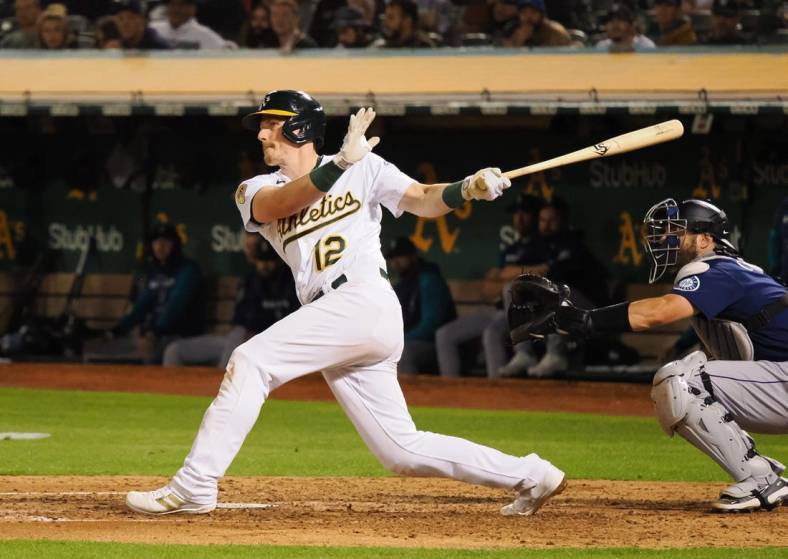 Sep 20, 2022; Oakland, California, USA; Oakland Athletics catcher Sean Murphy (12) hits an RBI double against the Seattle Mariners during the fifth inning at RingCentral Coliseum. Mandatory Credit: Kelley L Cox-USA TODAY Sports