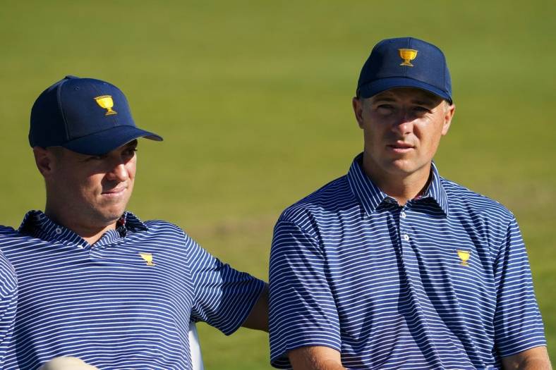 Sep 21, 2022; Charlotte, North Carolina, USA; Team USA golfer Justin Thomas (left) and Team USA golfer Jordan Spieth (right) sit before the team photo during a practice day for the Presidents Cup golf tournament at Quail Hollow Club. Mandatory Credit: Peter Casey-USA TODAY Sports