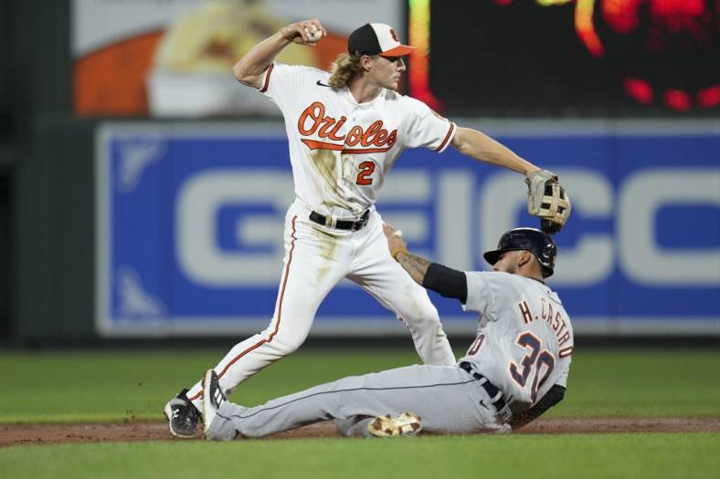Sep 21, 2022; Baltimore, Maryland, USA; Baltimore Orioles shortstop Gunnar Henderson (2) throws to first base for a double play as Detroit Tigers second baseman Harold Castro (30) slides into second base during the second inning at Oriole Park at Camden Yards. Mandatory Credit: Jessica Rapfogel-USA TODAY Sports
