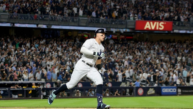 Sep 21, 2022; Bronx, New York, USA; New York Yankees right fielder Aaron Judge (99) runs to first base after hitting a ground rule double against the Pittsburgh Pirates during the fifth inning at Yankee Stadium. Mandatory Credit: Brad Penner-USA TODAY Sports